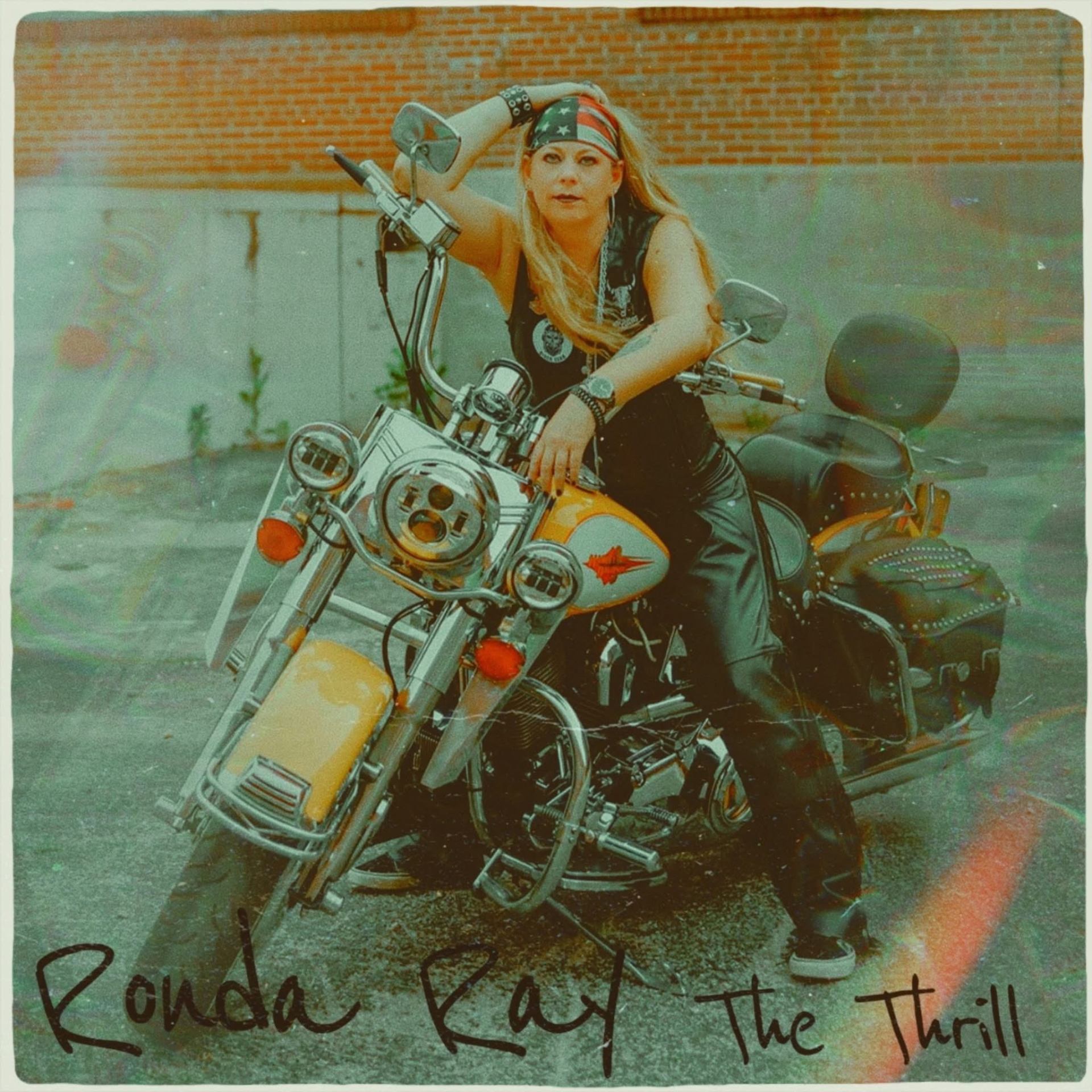 Ronda Ray performing live with a Harley in the foreground